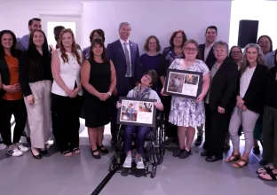 Group of representatives of the HomeShare co-ordinating organizations and campaign participants gather following the announcement.